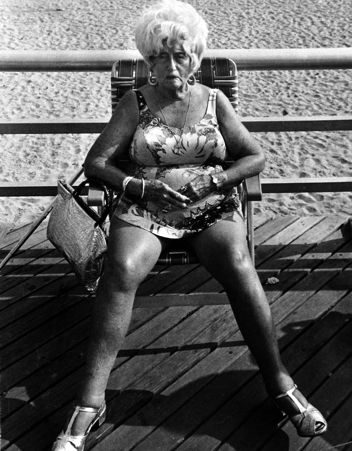 Coney Island (older woman in bathing suit
                      sitting in chair on boardwalk), ca 1970 Leon
                      Levinstein